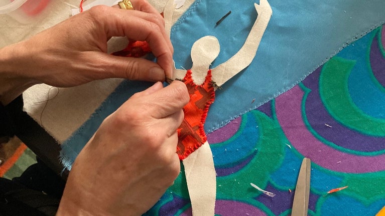 A workshop participant working on a Story Shelter panel